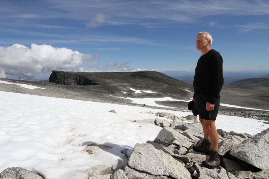 Reidar Marstein standing at the edge of an ice patch in the Jotunheimen Mountains.